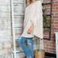 Woman wearing Bella Road Round Neck Batwing Sleeve Sweater with jeans and a hat, perfect for a cozy, stylish look.