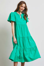 Woman wearing green HEYSON full size cotton poplin ruffled tiered midi dress, perfect for a stylish and comfortable warm weather look