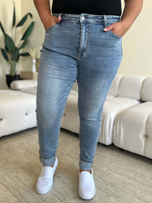 Person wearing Judy Blue high waist cuff hem skinny jeans standing in a stylish indoor setting.