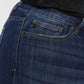 Close-up of Kancan mid-rise slim flare jeans in dark stone wash showcasing stretchy denim and classic zip fly.