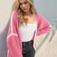 Woman wearing pink Double Take Contrast Cardigan with open front and dropped shoulder design for a chic, relaxed look.