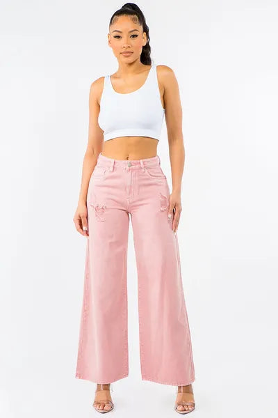 Chic model wearing American Bazi high waist distressed wide leg jeans paired with a crop top.