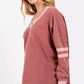 Mineral Wash Side Slit Contrast T-Shirt with long sleeves, V-neck, and band accents being worn by a model. Trendy and unique women's top.