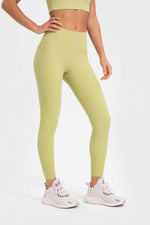 Millennia stretchy yoga leggings in vibrant lemon color, showcasing a wide waistband and perfect fit for workouts.