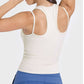 Back view of a stylish beige racerback tank top, showcasing its cutout design and comfortable fit for active wear.