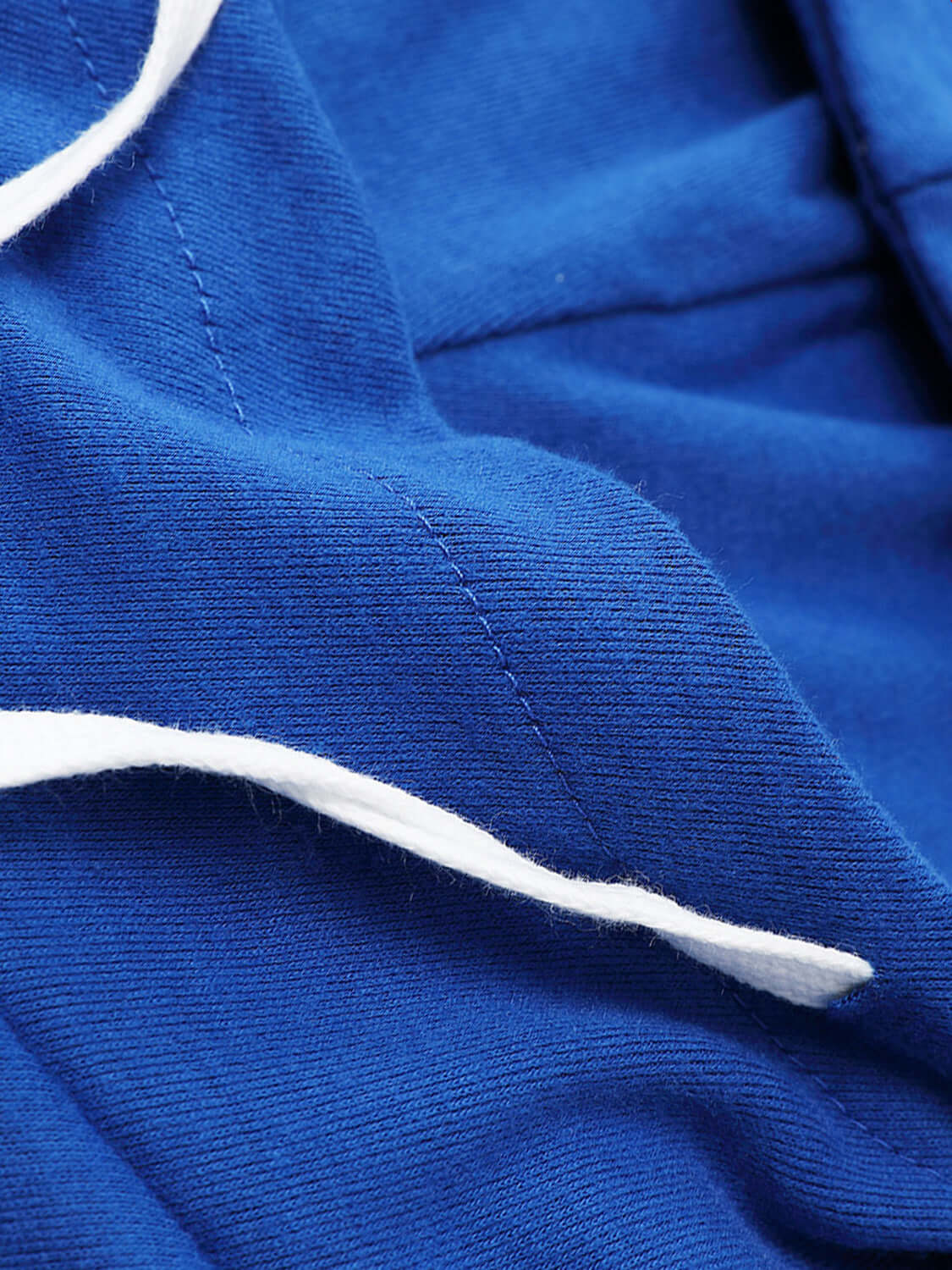 Close-up of Bella Road Drawstring Letter Graphic Long Sleeve Hoodie in blue fabric showcasing white drawstring and stitching details.