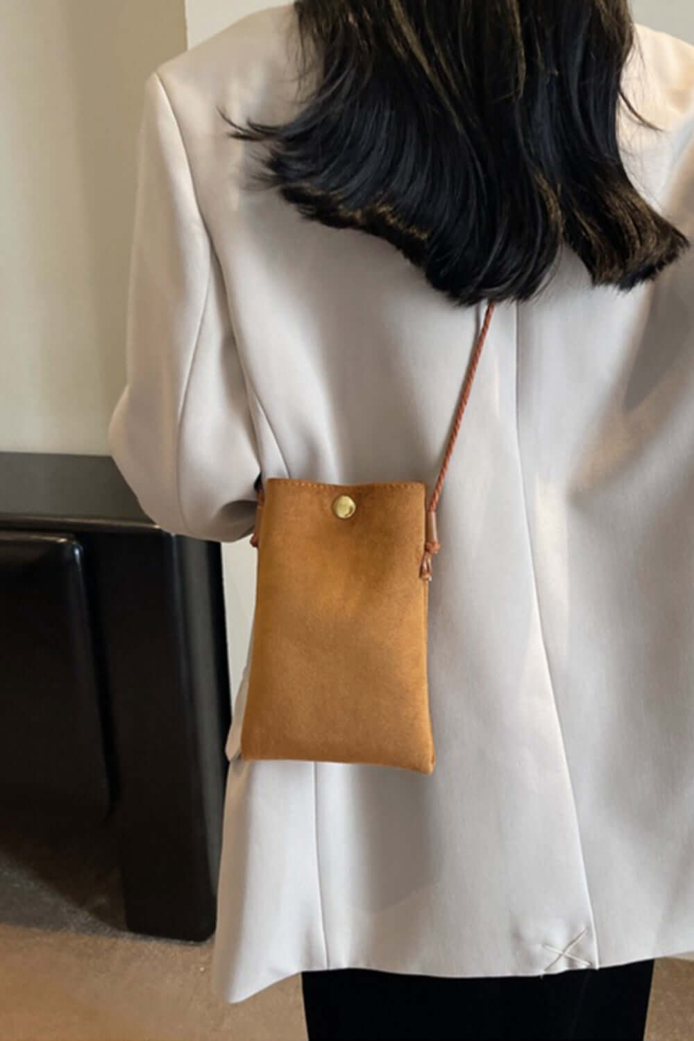 Woman wearing white blazer with Bella Road Suede Snap Down Crossbody Bag