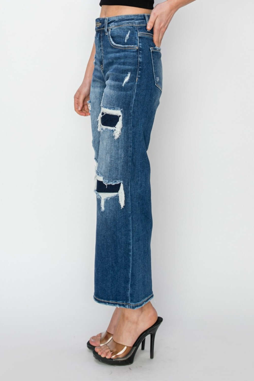 Model wearing high rise patch detailed wide leg crop jeans from Risen Jeans, featuring trendy rips and a modern wide leg silhouette.