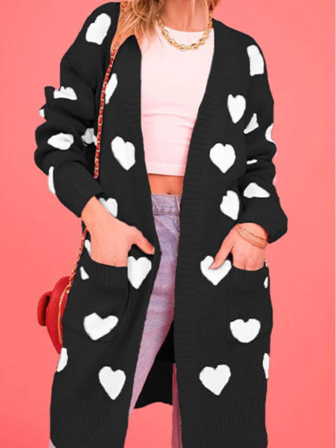 Woman wearing Bella Road Heart Open Front Long Sleeve Cardigan with white hearts design and pockets