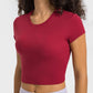 Millennia cropped sports t-shirt in vibrant red, perfect for yoga and fitness activities, featuring a stylish round neck design.