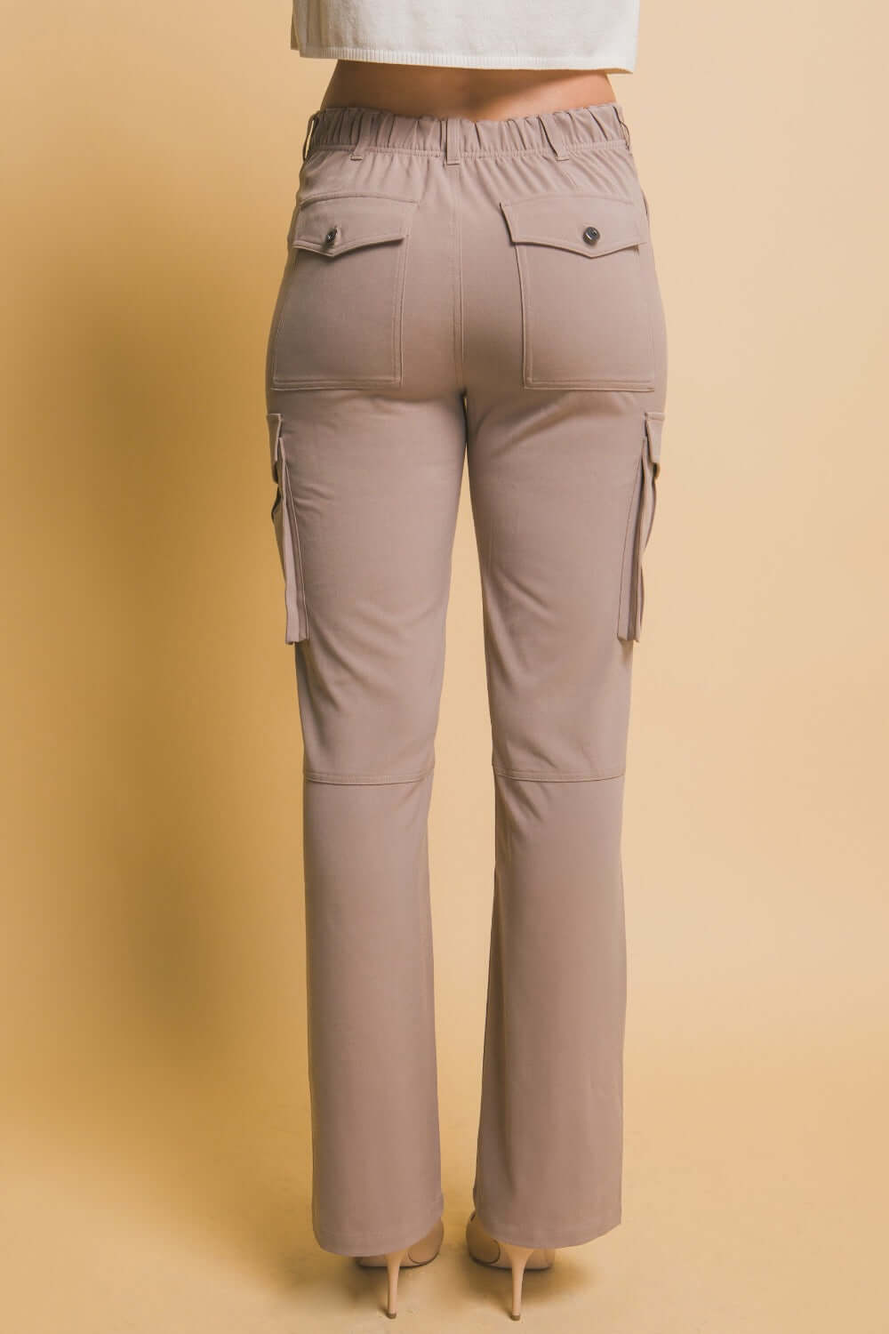 High rise cargo pants with practical pockets, featuring a flattering waist and relaxed fit for trendy, comfortable style.