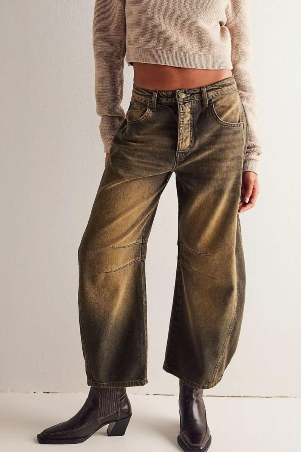 Model wearing wide leg jeans with pockets, features buttoned front, no stretch, 95% cotton and 5% polyester, styled with ankle boots.