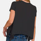 Woman wearing black slit high-low round neck t-shirt with blue jeans, modern trendy fashion.