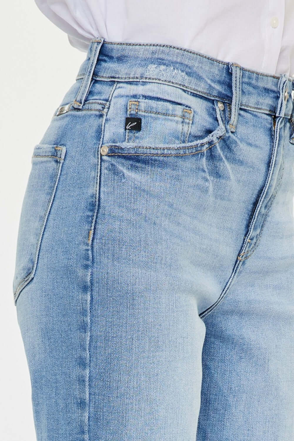 High Waist Raw Hem Straight Jeans - Close-up of high waistline with raw hem design in light denim color