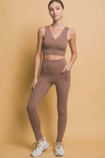 Love Tree high waist leggings in brown with side pockets, paired with a matching crop top against a warm background.