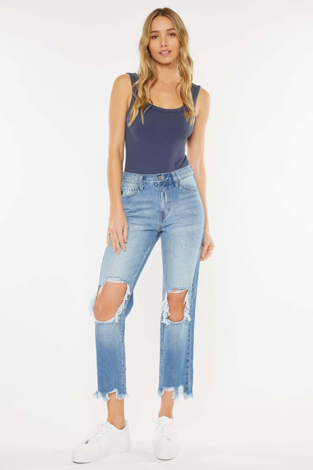 Woman wearing High Waist Chewed Up Straight Mom Jeans with distressed holes and frayed edges for a trendy, vintage-inspired look.