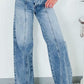 Woman wearing high waist wide leg jeans with pockets, slightly stretchy denim, casual and comfortable fit for a stylish look.