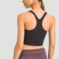 Stylish back view of Millennia Racerback Sports Bra in black, perfect for yoga and workouts with removable padding.