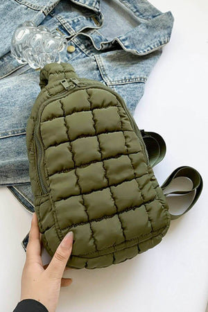 Olive green Bella Road Quilted Nylon Crossbody Bag on denim jacket, ideal lightweight travel accessory in puffy quilted design.