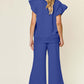 Woman wearing blue texture ruffle short sleeve top and drawstring wide leg pants set, back view.