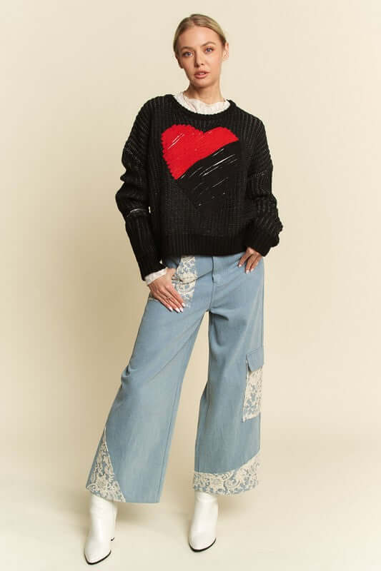 Model showcasing Davi & Dani Contrast Heart Dropped Shoulder Sweater paired with stylish denim, exuding cozy winter vibes.