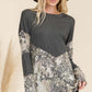 Fashionable mixed animal print long sleeve t-shirt, v-shaped design, paired with jeans, perfect for a trendy fall look.