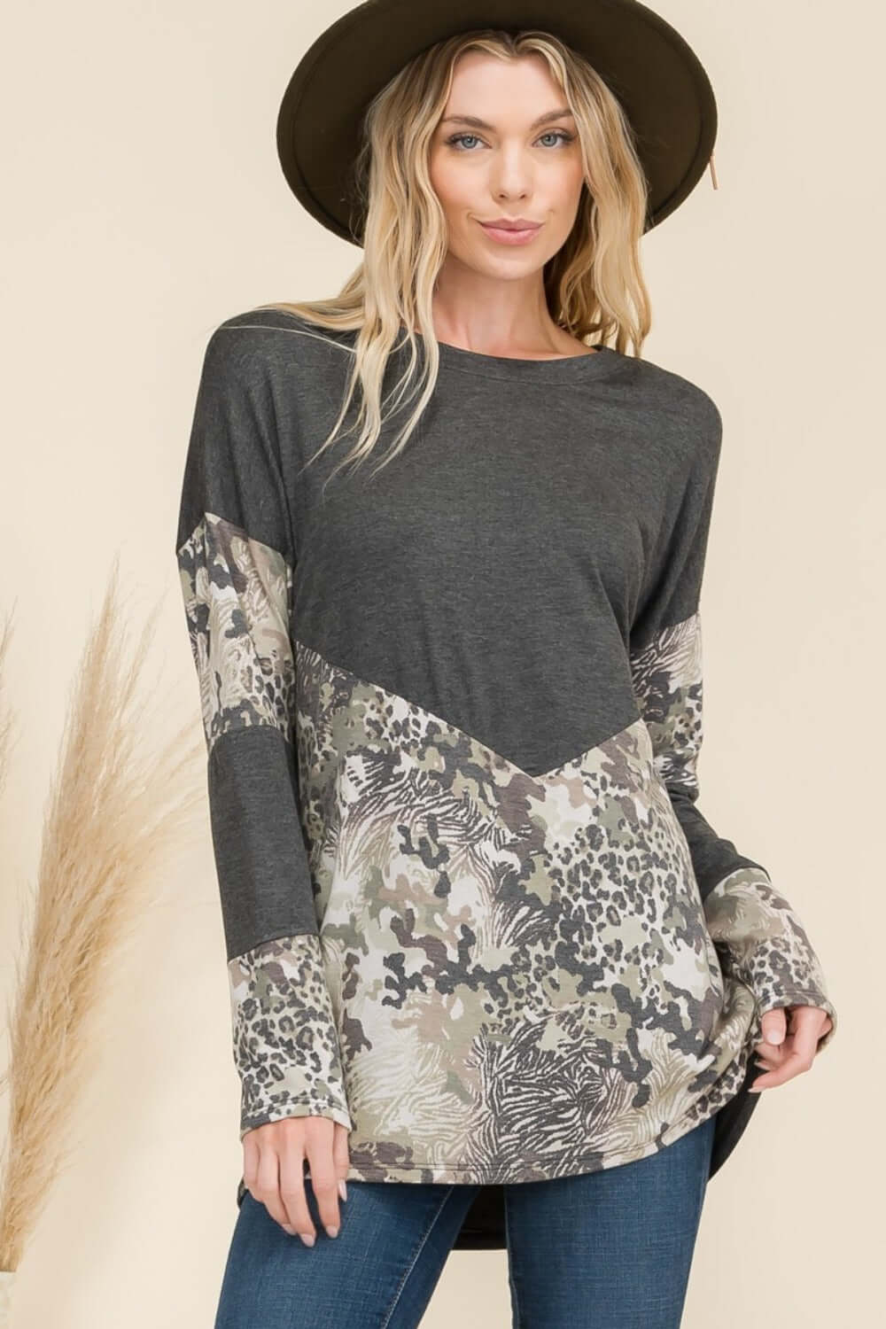 Fashionable mixed animal print long sleeve t-shirt, v-shaped design, paired with jeans, perfect for a trendy fall look.