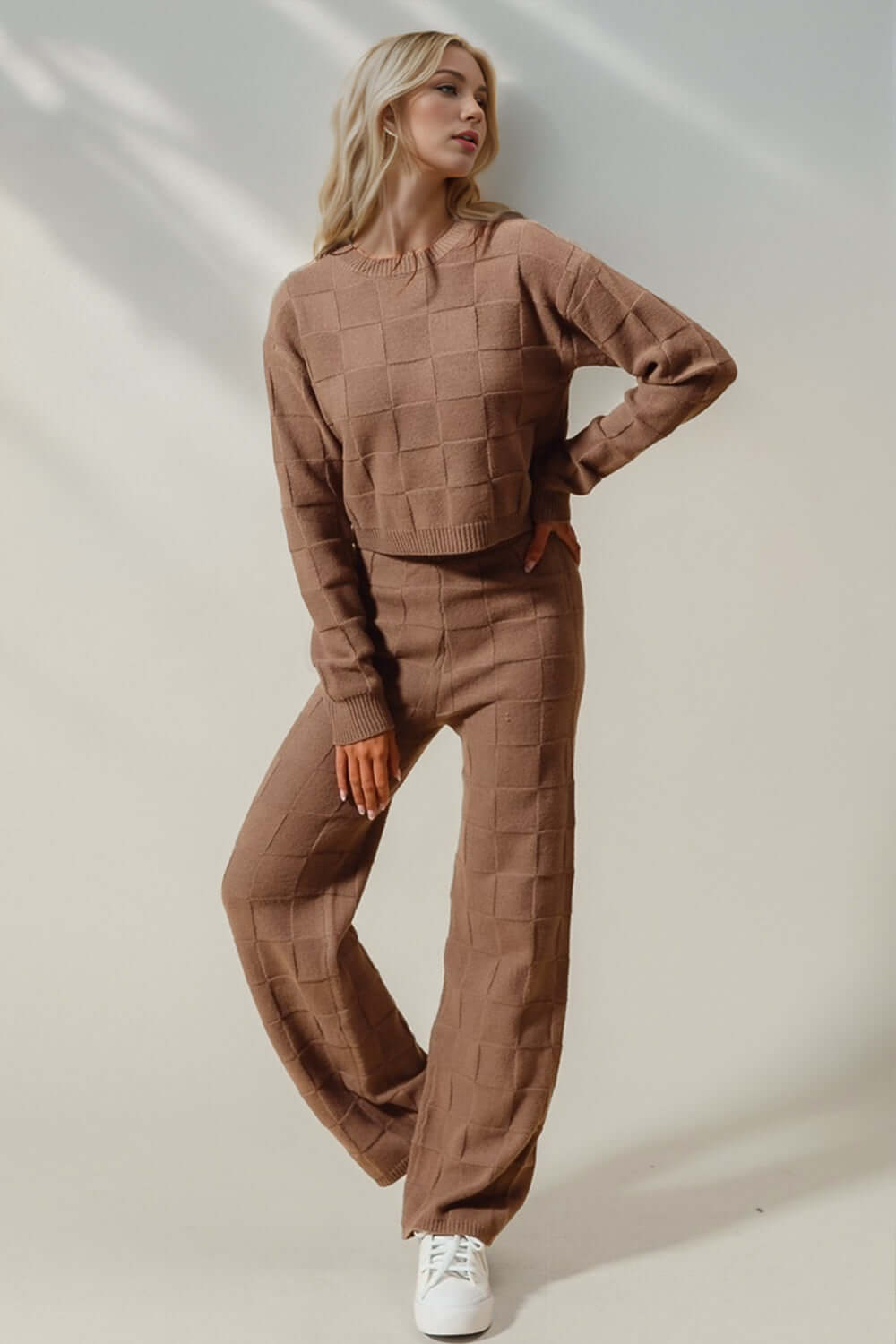 Woman wearing Double Take Checkered Round Neck Top and Pants Set in brown, stylish leisure wear for an edgy fashion statement.