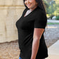 Woman wearing Basic Bae Bamboo Full Size V-Neck Short Sleeve T-Shirt in black, standing outdoors.