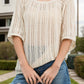 Bella Road Swim Openwork Round Neck Cover-Up in sheer beige, perfect for summer beach outings, styled with denim shorts.