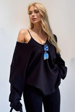 Woman wearing Basic Bae V-Neck Dropped Shoulder Long Sleeve Sweatshirt with Bra, features dropped shoulders and built-in bra, in black.