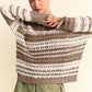 Model showcases Davi & Dani Contrast Striped Crochet Drop Shoulder Knit Cover Up in neutral tones with relaxed styling.