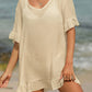 Woman wearing a tied ruffled half sleeve cover-up made of sheer cotton and polyester blend on a beach.