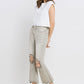 Woman wearing Lovervet distressed raw hem cropped flare jeans with a white top and heels.