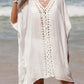 Woman wearing white cutout V-neck three-quarter sleeve cover-up on the beach with ocean background