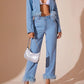 Model wearing a stylish light blue denim outfit with feather details and a matching handbag, perfect for a chic look.