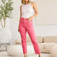 Woman wearing Crop Dylan Full Size Tummy Control High Waist Raw Hem RFM Jeans in a stylish room