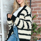 Woman wearing Bella Road Striped Contrast Open Front Long Sleeve Cardigan with unique design for stylish layering.