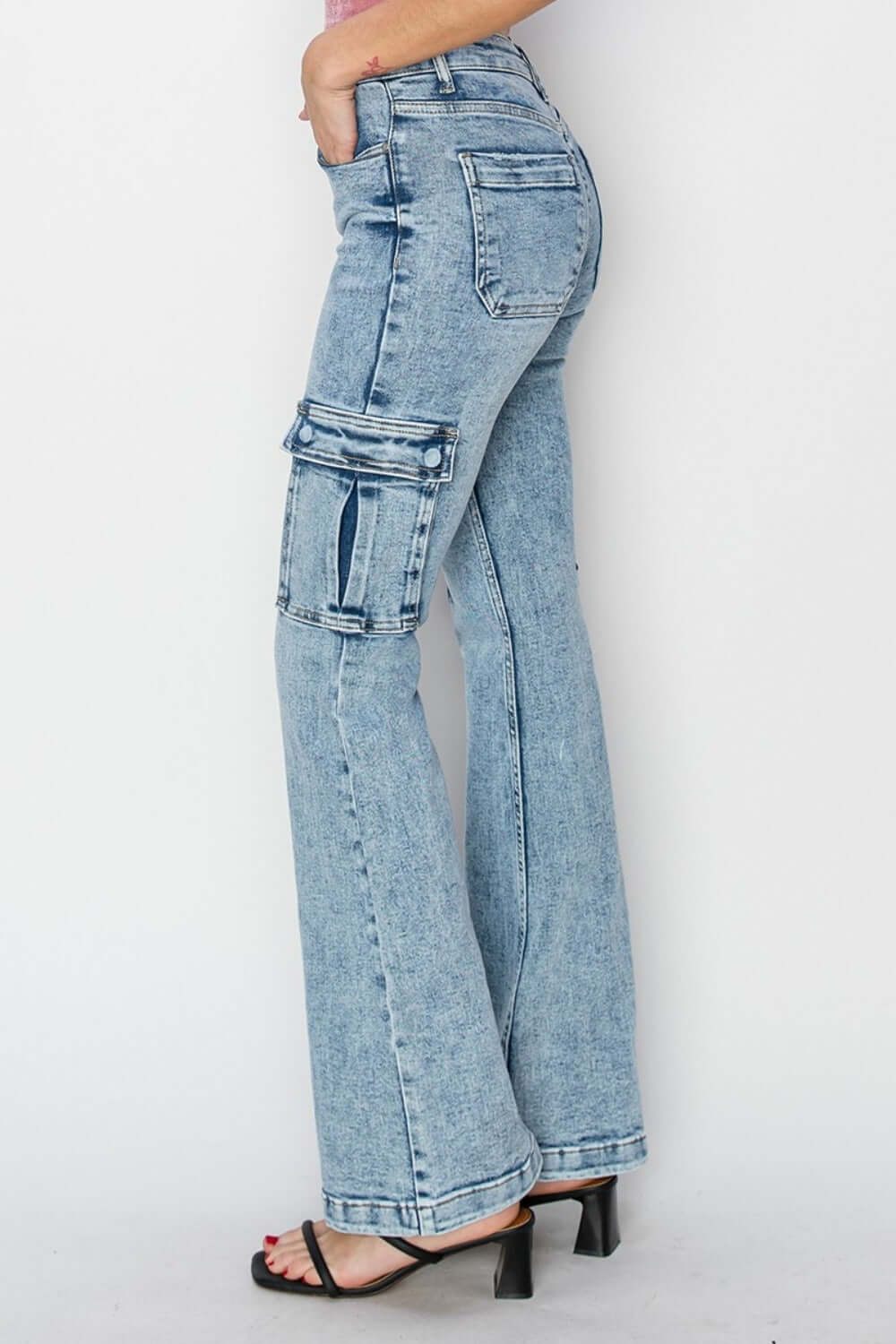 Risen high rise cargo flare jeans with functional pockets and trendy retro style, enhancing silhouette in light blue denim.