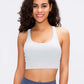 Stylish woman modeling a light gray Millennia Crisscross Scoop Neck Active Tank for workouts and yoga.