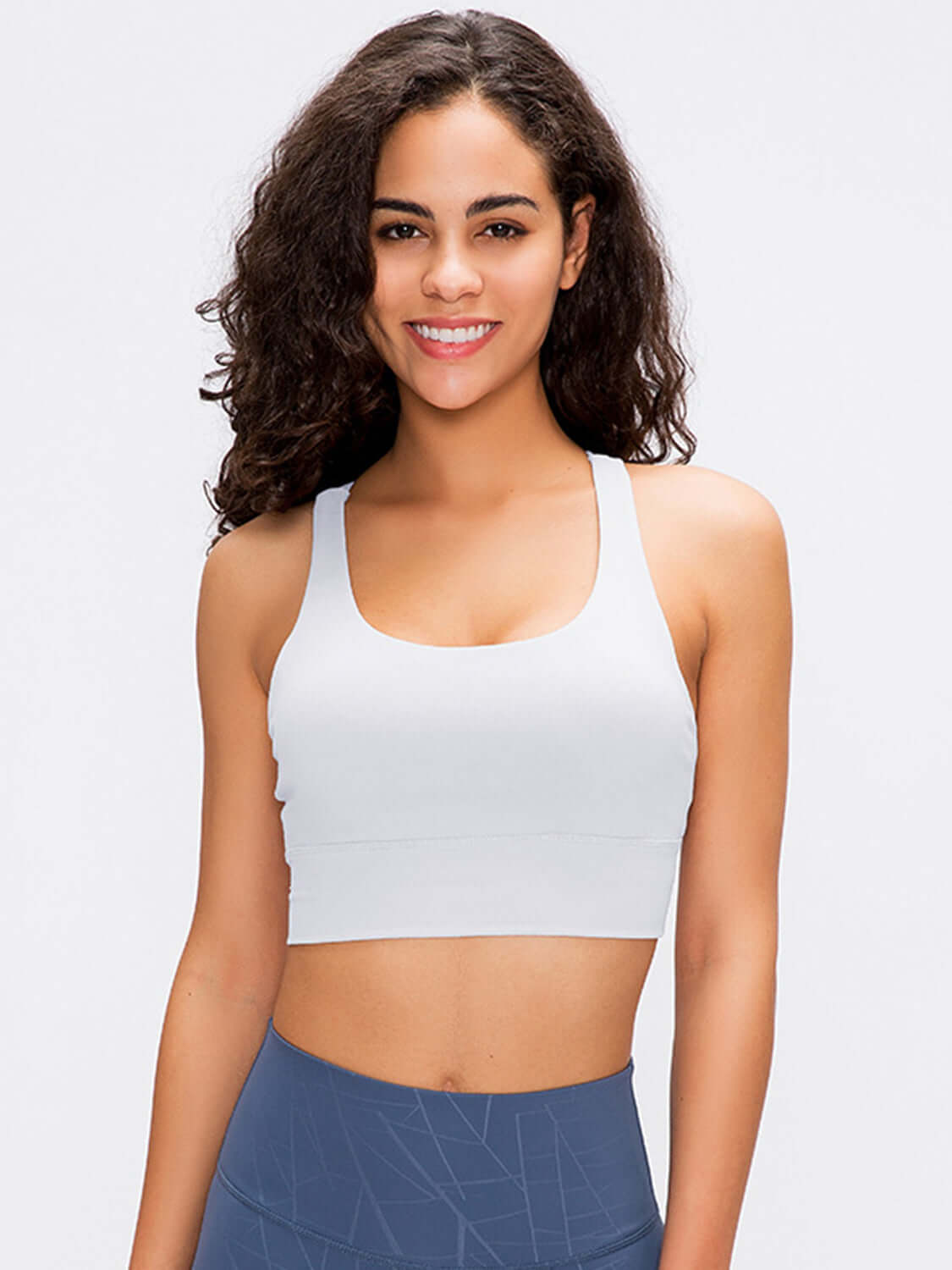 Stylish woman modeling a light gray Millennia Crisscross Scoop Neck Active Tank for workouts and yoga.