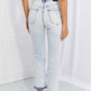 Woman wearing Camille Acid Wash Crop Straight Jeans by Risen Jeans, showcasing the back view with slight distressing and trendy cropped length