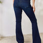 Woman wearing Mid Rise Flare Jeans, showcasing a timeless, non-distressed silhouette with a comfortable stretch fit.