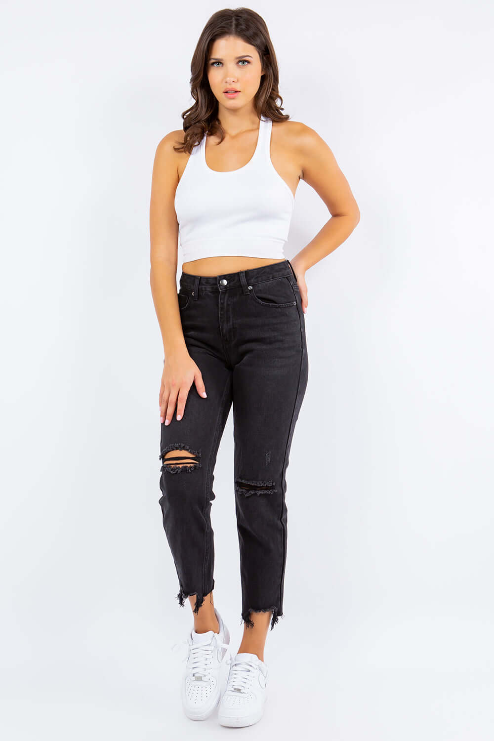 Stylish woman models High Waist Distressed Cropped Straight Jeans in black with edgy ripped details and a high waist for a trendy look.