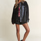 Stylish faux leather sherpa snap jacket paired with floral top and sequin shorts, showcasing trendy and versatile fashion.