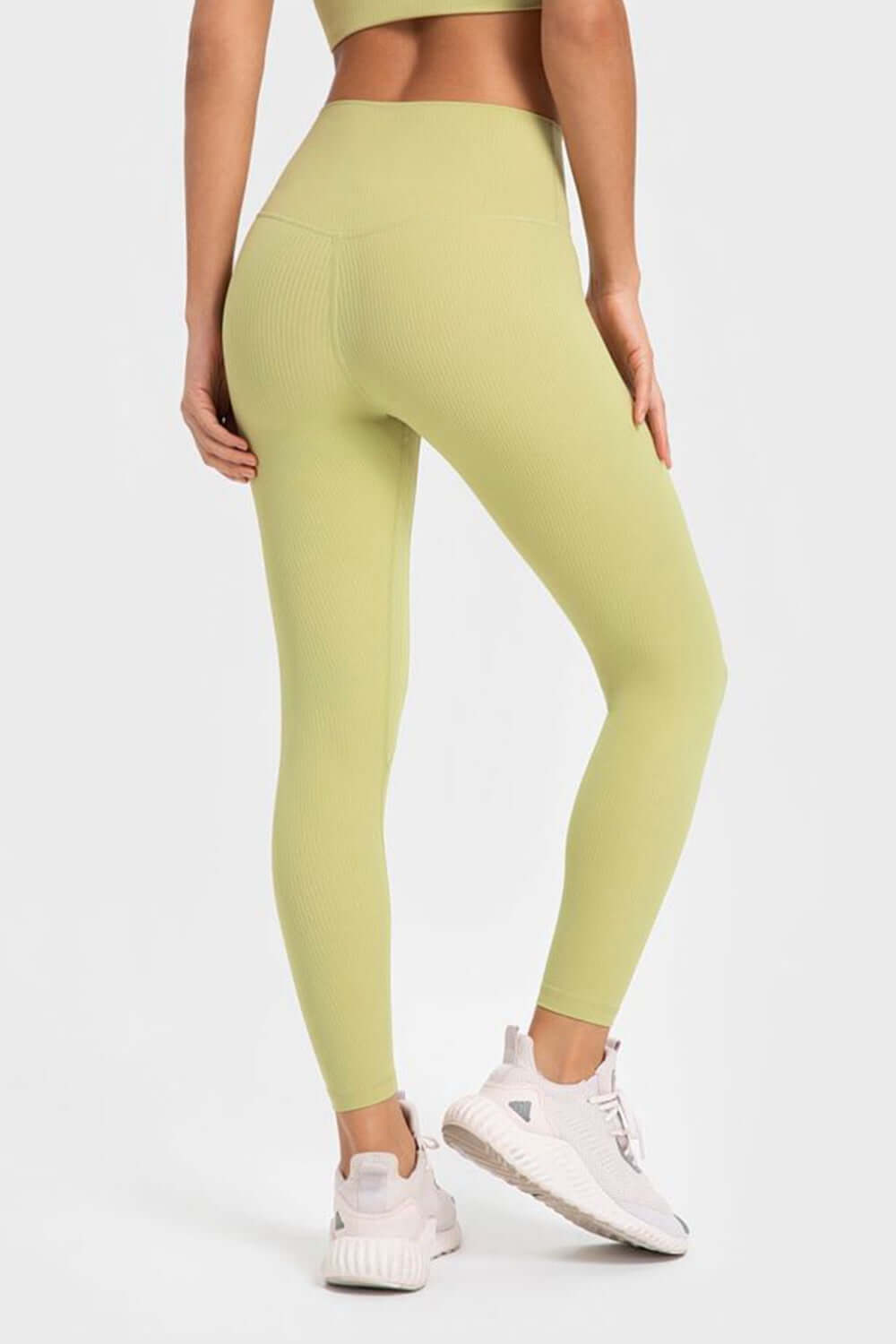 Millennia Highly Stretchy Wide Waistband Yoga Leggings in soft green, showcasing a flattering fit from the back. Perfect for yoga!