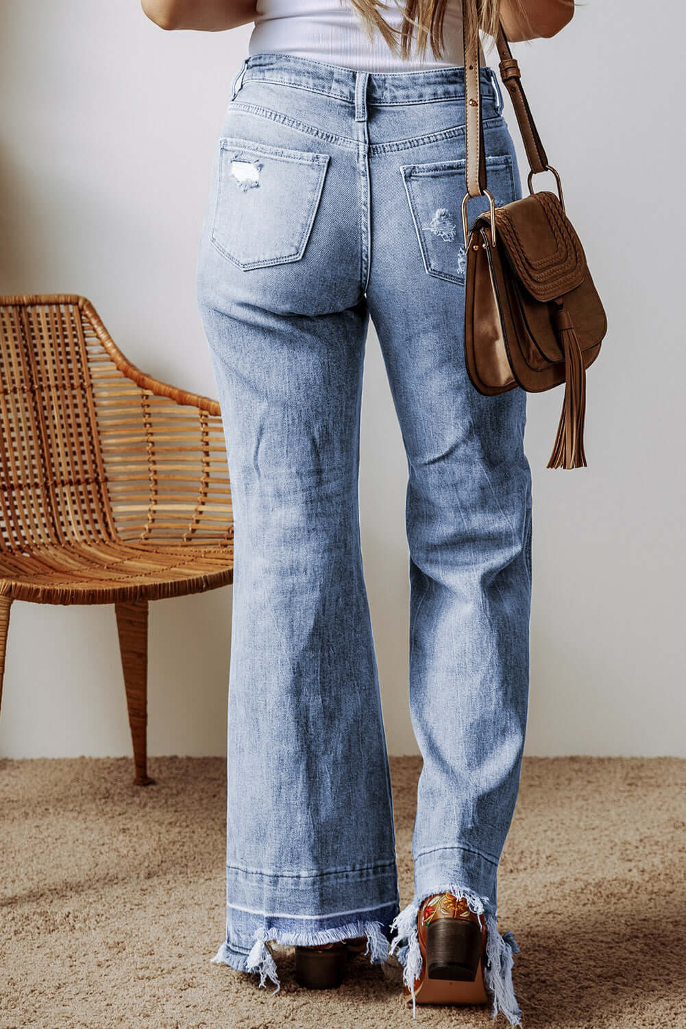 Raw hem bootcut jeans with pockets for petite women, back view.