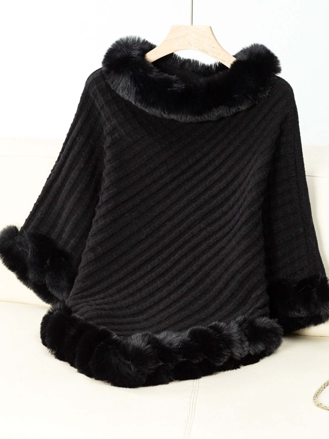 Cozy black Bella Road poncho with fuzzy trim and three-quarter sleeves for stylish warmth on chilly days.