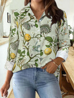 Woman wearing Bella Road Lemon Printed Collared Neck Long Sleeve Shirt with jeans in a modern home setting.