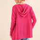 Woman wearing a pink thermal hooded open front cardigan with pockets, showcasing the back view. Ideal for cozy lounging or casual outings.